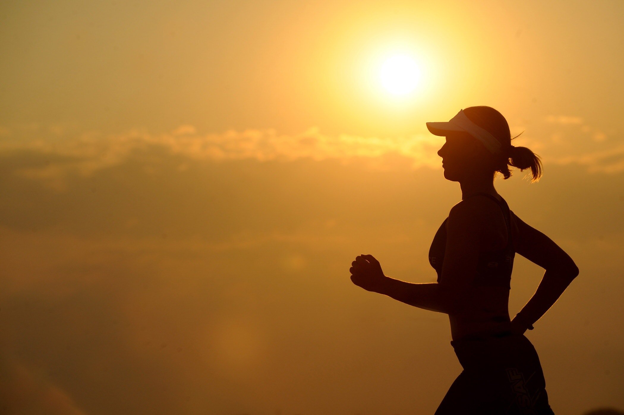 A silhouette of a woman running.